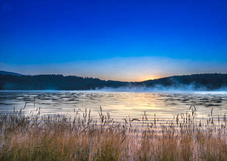 early morning with fog on the lakeの写真素材