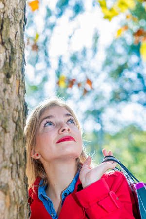 woman lookin up with shopping bagの写真素材