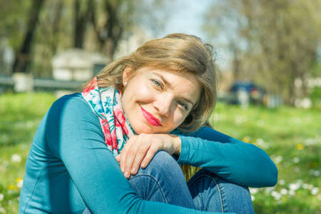 Happy young smiling woman in the parkの写真素材