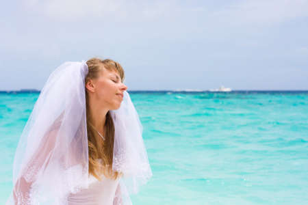 Bride on a coastline at tropical beachの写真素材