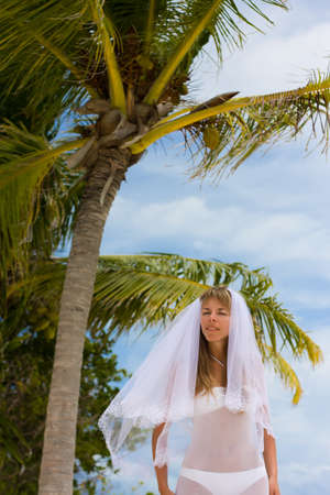 Bride on a coastline at tropical beachの写真素材