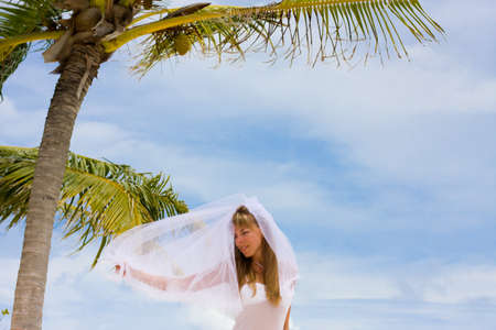 Bride on a coastline at tropical beachの写真素材