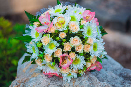 Wedding rings are on the bride's bouquet in the parkの写真素材