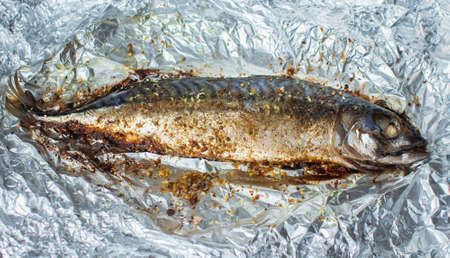 Baked mackerel with herbs in foil.の写真素材