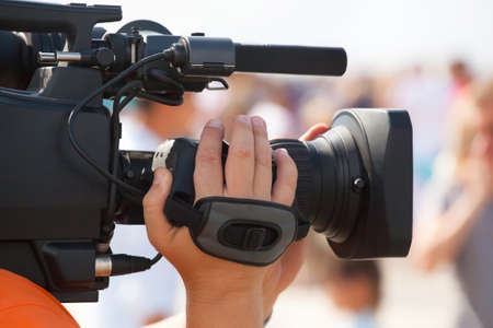 The operator photographer takes on a professional camera, interviews in the mass celebration.の写真素材