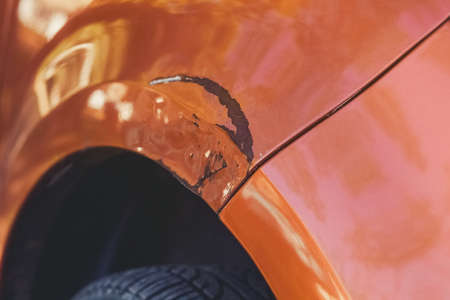 Scratching on the front of the car's wing in a car repair shop.の写真素材