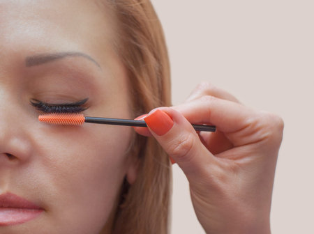 Beautiful Woman with long eyelashes in a beauty salon. Eyelash extension procedure. Lashes close upの写真素材