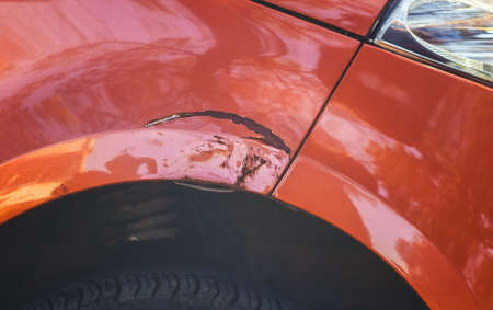 Scratching on the front of the car's wing in a car repair shop.の写真素材