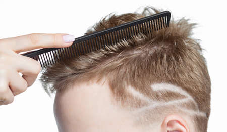 Men's creative haircut in the beauty salon. Hair care and hair styling.の写真素材