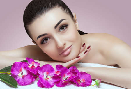 Portrait of a beautiful woman in a spa salon in front of a beauty treatment. Professional skin care.の写真素材