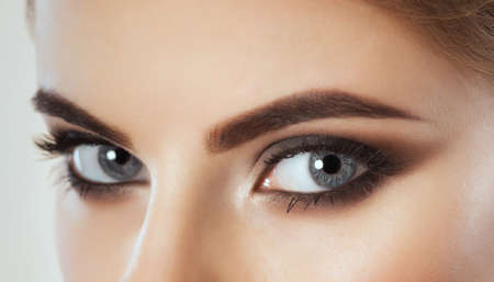 Beautiful Woman with long lashes and beautiful make-up looking at the camera.の写真素材
