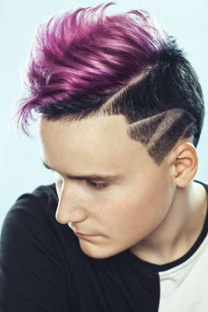 Portrait of a beautiful young teenager with a beautiful creative hairstyle, hair painted in pink.の写真素材