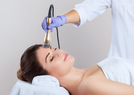 Portrait of woman getting rf-lifting on face and neck. Rf lifting procedure in a beauty parlour.