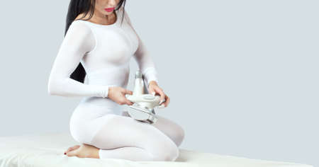 The woman does hardware anti-cellulite lpg massage in a beauty salon. Cosmetology skin careの写真素材