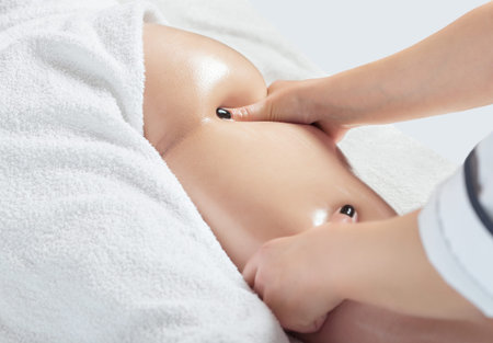 Masseur makes anti-cellulite massageon the legs, thighs, hips and buttocks in the spa. Overweight treatment, body sculpting.Cosmetology and massage concept.の写真素材