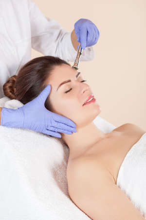 Procedure Microdermabrasion of the face skin of a beautiful woman in a beauty salon.Cosmetology and professional skin care.の写真素材