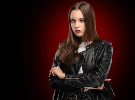Brunette girl with beautiful makeup, with clean skin, long hair in a black leather jacket.