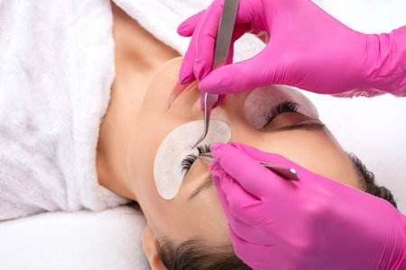 Beautiful Woman with long eyelashes in a beauty salon. Eyelash extension procedure. Lashes close up