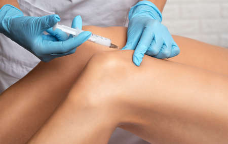 cosmetologist makes lipolytic injections to burn fat of a woman. Female aesthetic cosmetology in a beauty salon.Cosmetology concept.の写真素材