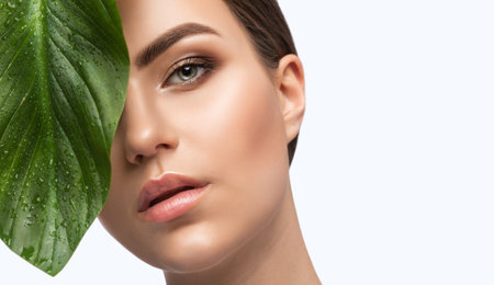 Portrait of attractive girl with healthy clean skin and beautiful make-up. Aesthetic cosmetology and makeup concept.の写真素材