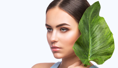 Portrait of attractive girl with healthy clean skin and beautiful make-up. Aesthetic cosmetology and makeup concept.の写真素材
