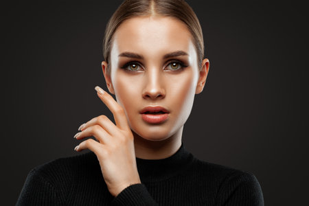 Portrait of attractive girl with healthy clean skin and beautiful make-up. Aesthetic cosmetology and makeup concept.の写真素材