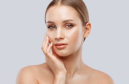Portrait of attractive girl with healthy clean skin and beautiful make-up. Aesthetic cosmetology and makeup concept.の写真素材