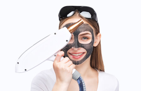 Carbon peeling procedure to beautiful blue-eyed girl in a beauty salon. hardware cosmetology treatment.の写真素材