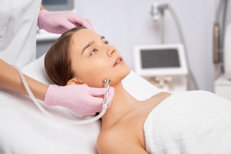 Procedure microdermabrasion on the face against acne and blackheads. Women's cosmetology in the beauty salon.の写真素材
