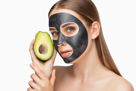 carbon peeling procedure to beautiful girl in a beauty salon. Girl with avocado.Hardware cosmetology treatment.の写真素材