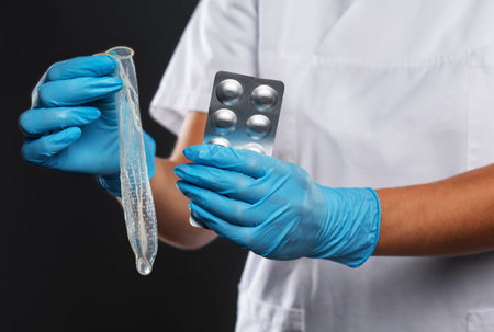 The doctor talks about the methods of contraception. It contains a condom and birth control pills.の写真素材