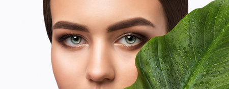 Portrait of attractive girl with healthy clean skin and beautiful make-up. Aesthetic cosmetology and makeup concept.の写真素材
