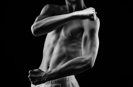 Bodybuilder shows his muscles on the body. he concept of proper nutrition and healthy lifestyle. photo black and whiteの写真素材