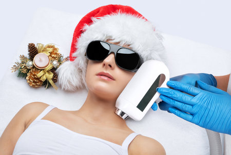 Elos epilation hair removal procedure on a woman's face. Beautician doing laser rejuvenation in a beauty salon. Removing unwanted body hair. hardware ipl cosmetologyの写真素材