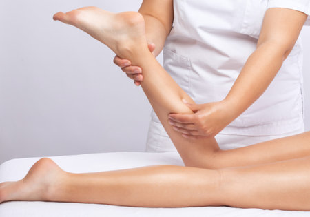 Masseur makes anti-cellulite massage on the legs in the spa. Overweight treatment, body sculpting.Cosmetology and massage concept.の写真素材