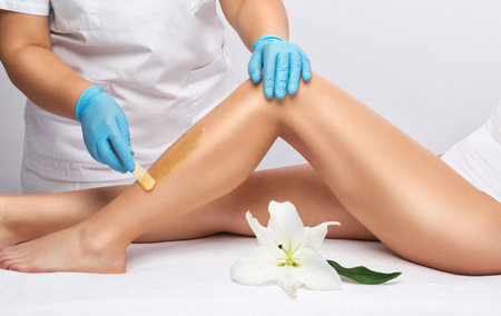 Elos epilation hair removal procedure on a woman's body. Beautician doing laser rejuvenation in a beauty salon. Removing unwanted body hair. Hardware ipl cosmetologyの写真素材