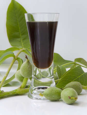 Glass of liqueur from young green walnuts-Juglans regiaの写真素材