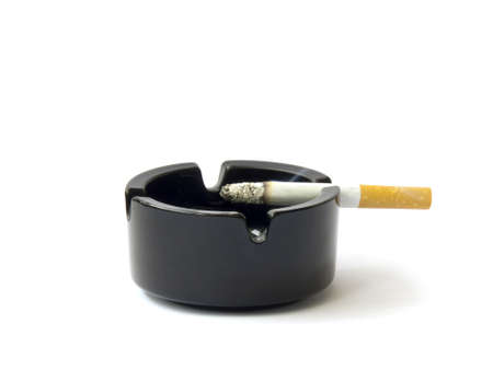 Burning cigarette smoking on ashtray-isolated on whiteの写真素材