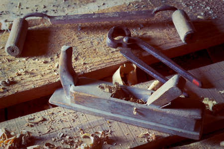 Old carpenter's tools on wooden boardsの写真素材
