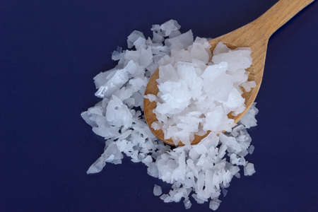 Magnesium chloride -sea salt in wooden spoons-close upの写真素材