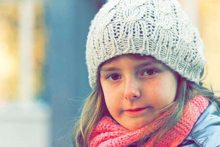 Girl in knitted winter cap and scarfの写真素材