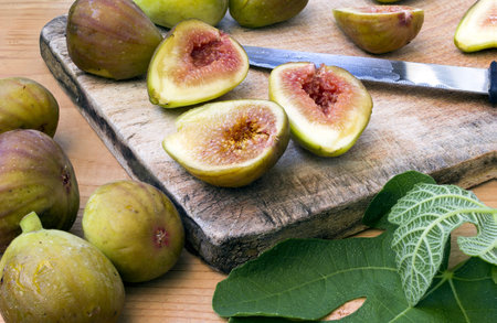 Fresh and healthy organic figs on a wooden board slashed in half