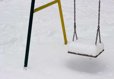 Close-up of chain swing in snowy areaの写真素材