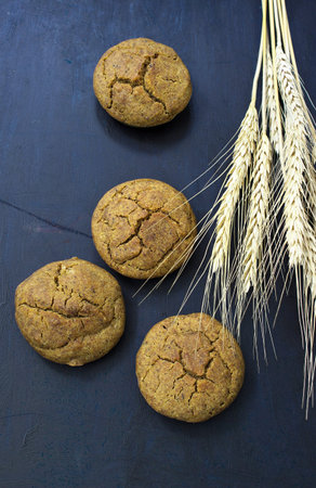 Fresh baked grain cookies on dark background