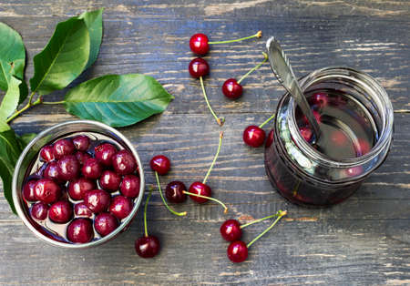 Canned compote of cherries in a jar served in a glass bowlの写真素材