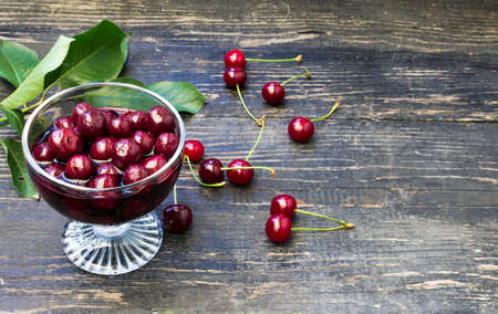 Homemade cherry compote in a glass with berriesの写真素材
