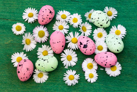 Easter background with colorful eggs and spring flowersの写真素材