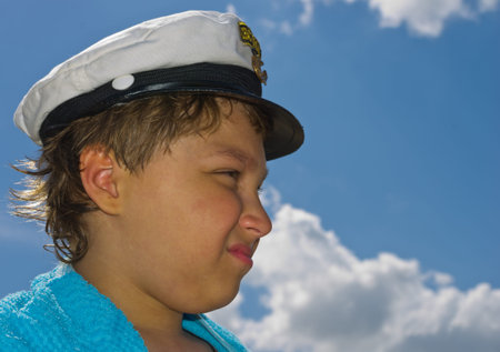 The boy looks into the distance after swimming against the sky