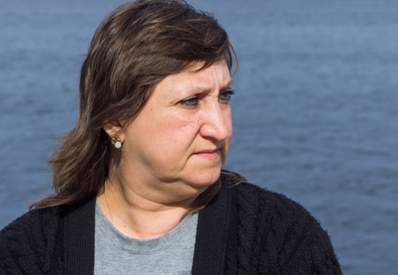 Portrait of middle-aged woman on background of water