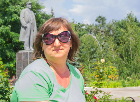 Portrait of a woman on the background of the monument to Lenin in the town of Skadovsk